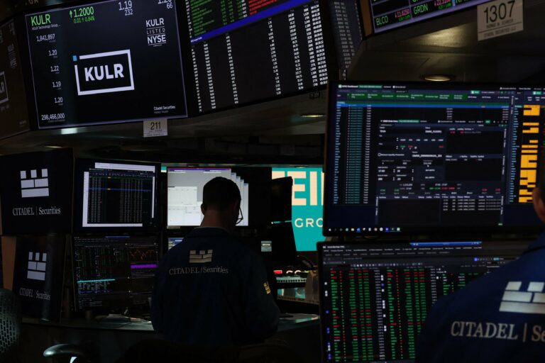 Traders work on the floor of the New York Stock Exchange (NYSE) at the opening bell