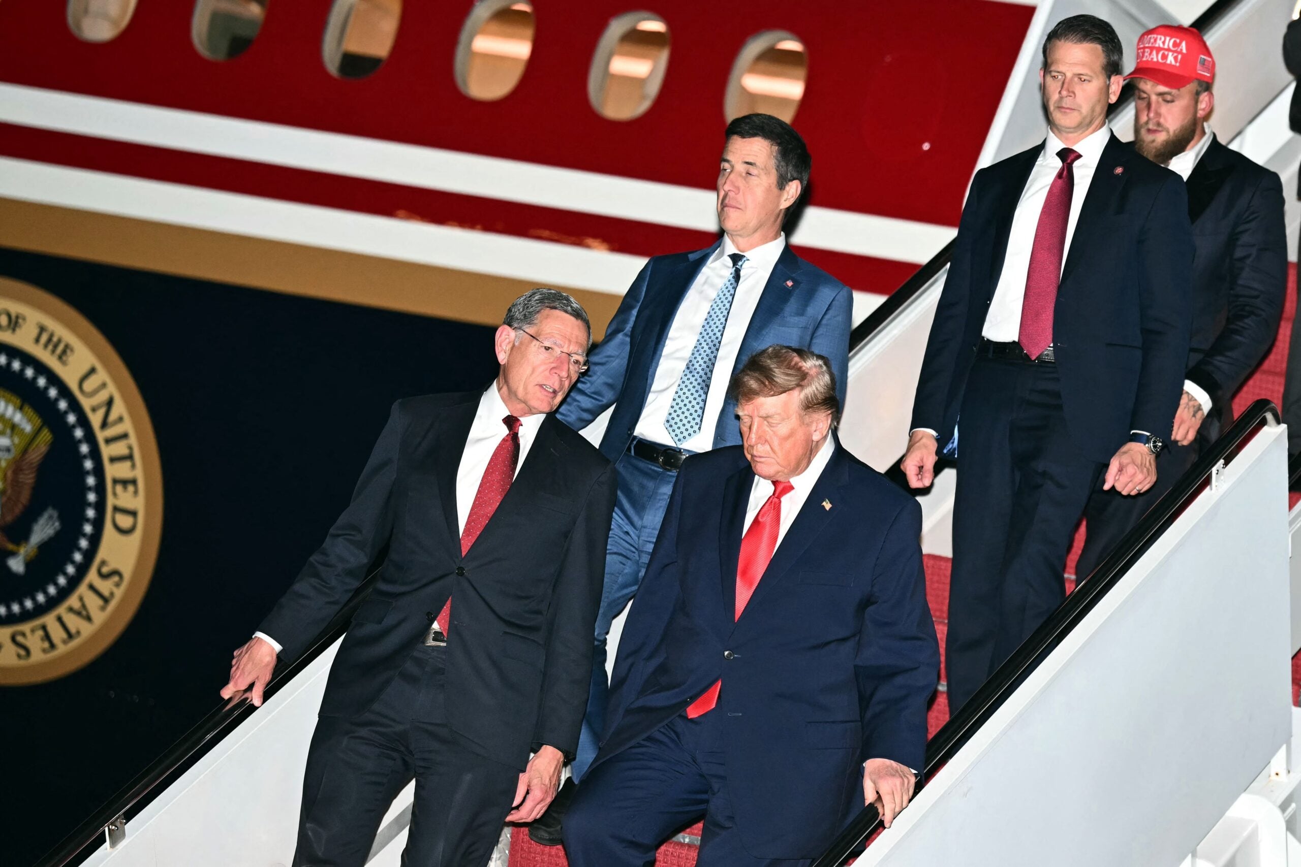 Donald Trump disembarks Air Force One accompanied by US Senators John Barrasso (L), Republican from Wyoming, Bernie Moreno (C), Republican from Ohio, and US boxer and influencer Jake Paul at Joint Base Andrews, Maryland on October 12, 2026. AFP / LEHTIKUVA / KENT NISHIMURA