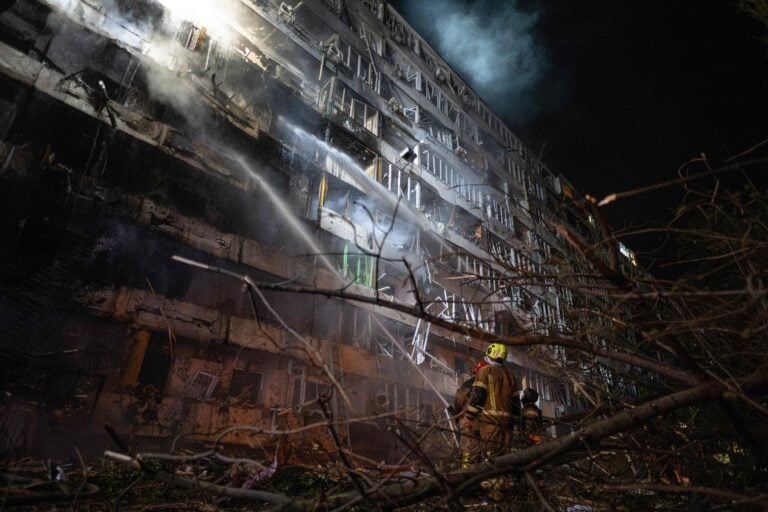 Ukrainian firefighters extinguish a blaze at the site of a Russian missile strike at an apartment building in Kyiv on October 14, 2026. / AFP / LEHTIKUVA / GENYA SAVILOV