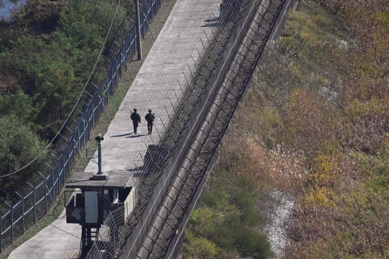 South Korean soldiers patrol along a military fence on the south side of the Demilitarised Zone (DMZ) dividing the two Koreas. / AFP / LEHTIKUVA / JUNG YEON-JE